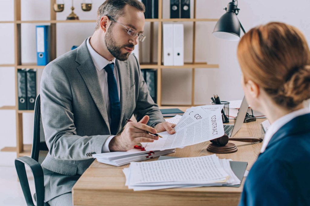 Lawyer reviewing contract with client