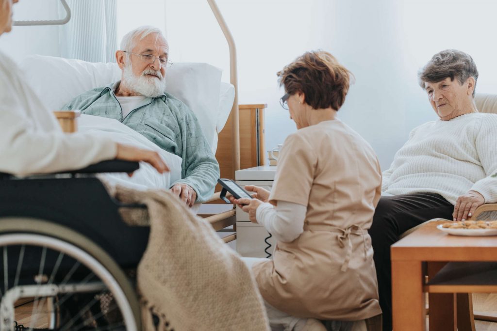 Caregiver checking elderly residents in nursing home