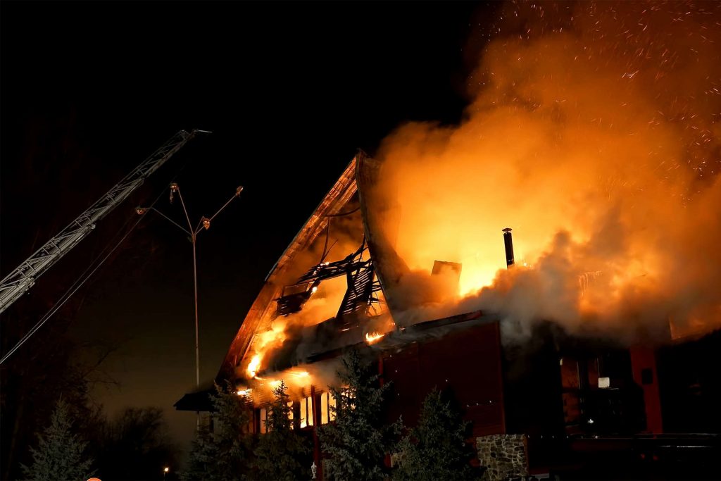 House engulfed in flames at night